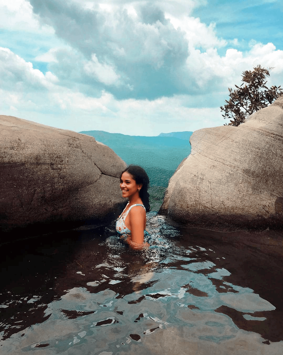 Swimming in a natural rock pool at the top of Diyaluma Falls near Ella