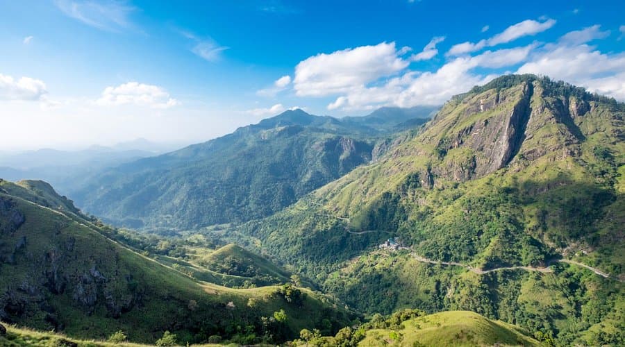 Green mountains and the valley of the Ella Gap in Ella, Sri Lanka, under a blue sky